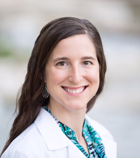 Sara Stuart, D.O. smiling in a white coat